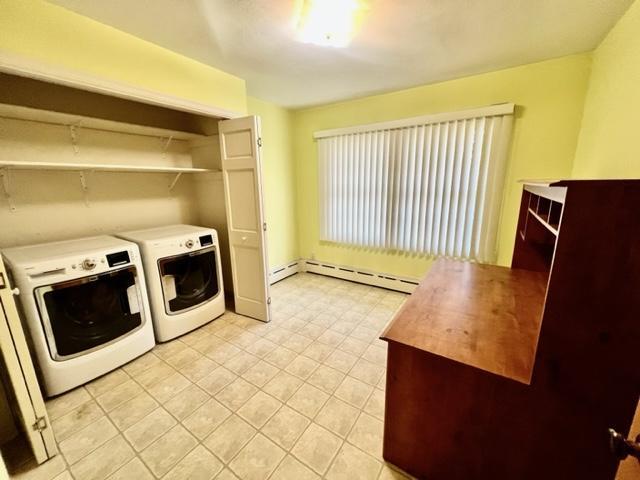 laundry area featuring independent washer and dryer and baseboard heating