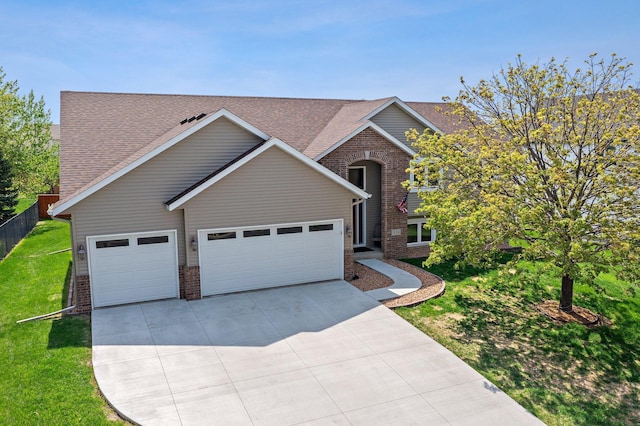 214 15th Ave SE, Lonsdale, MN 55046 - traditional home featuring brick siding, a garage, concrete driveway, and roof with shingles