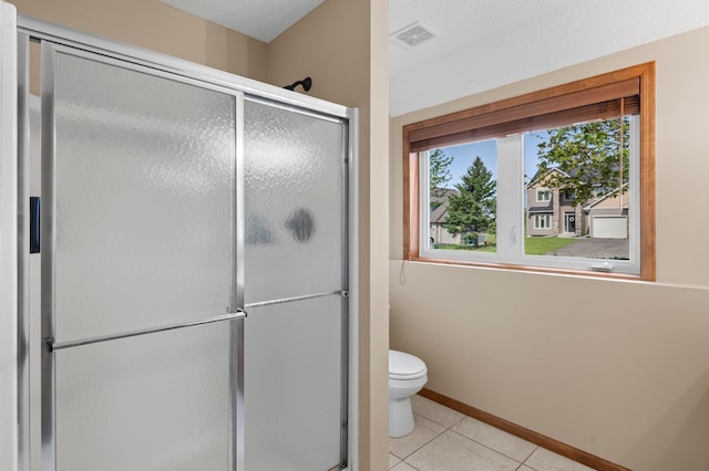 214 15th Ave SE, Lonsdale, MN 55046 - full bath featuring a shower stall, toilet, tile patterned floors, and baseboards