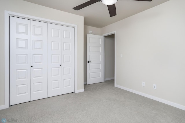 unfurnished bedroom featuring a closet, ceiling fan, and light carpet