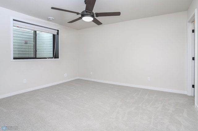 empty room featuring light carpet and ceiling fan