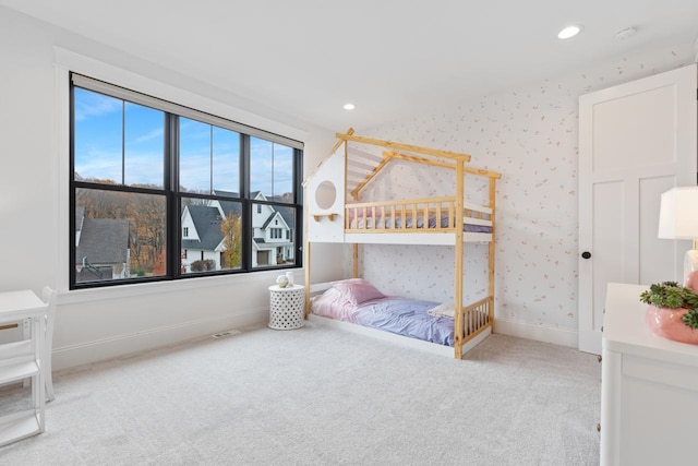 bedroom featuring baseboards, recessed lighting, light colored carpet, and wallpapered walls