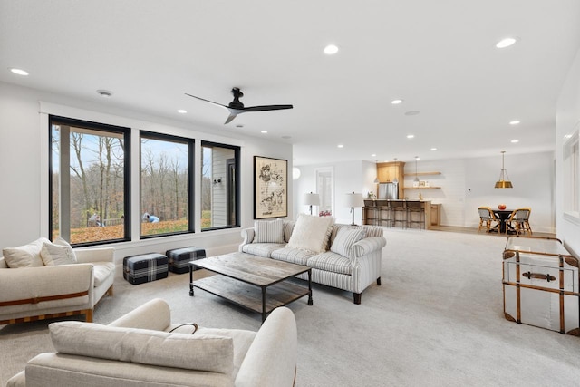 living room with recessed lighting and light colored carpet