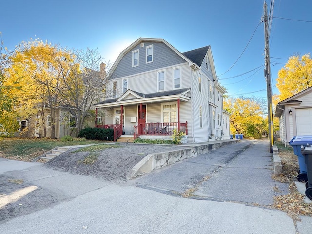 view of front of home featuring aphalt driveway and a porch