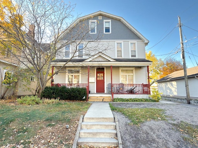 view of front of property with a porch and a front lawn