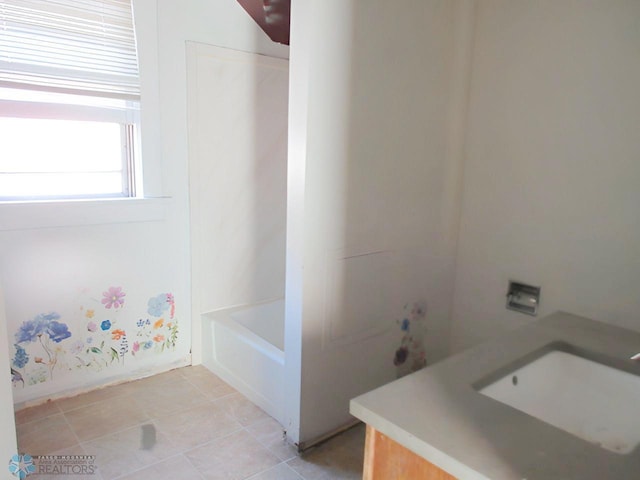 bathroom featuring vanity and a tub to relax in