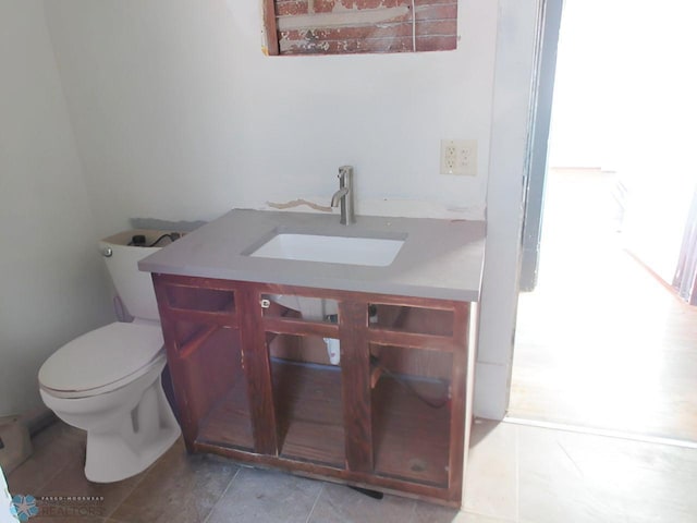 bathroom featuring vanity, toilet, and tile patterned flooring