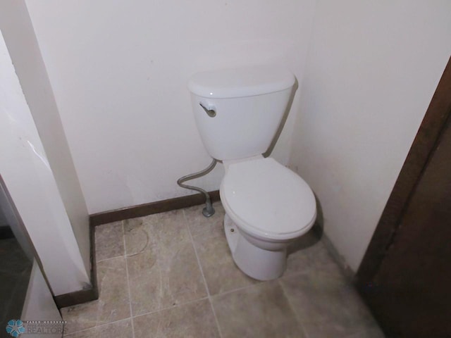 bathroom with toilet and tile patterned floors