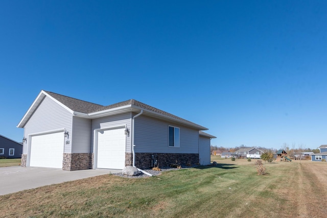 view of property exterior featuring a garage and a lawn