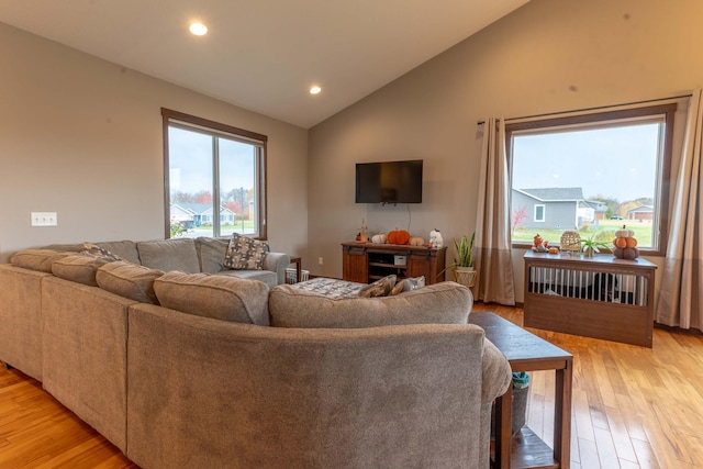 living room with vaulted ceiling and light hardwood / wood-style flooring