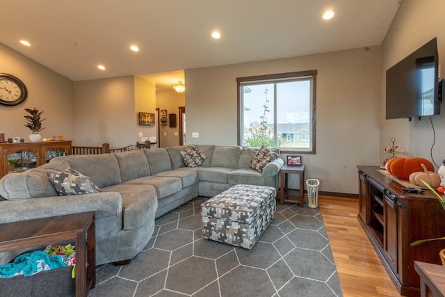 living room with lofted ceiling and hardwood / wood-style flooring