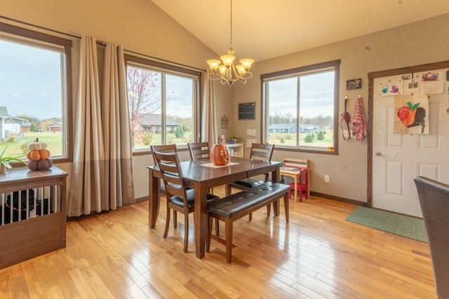 dining room featuring light hardwood / wood-style floors, a chandelier, and vaulted ceiling