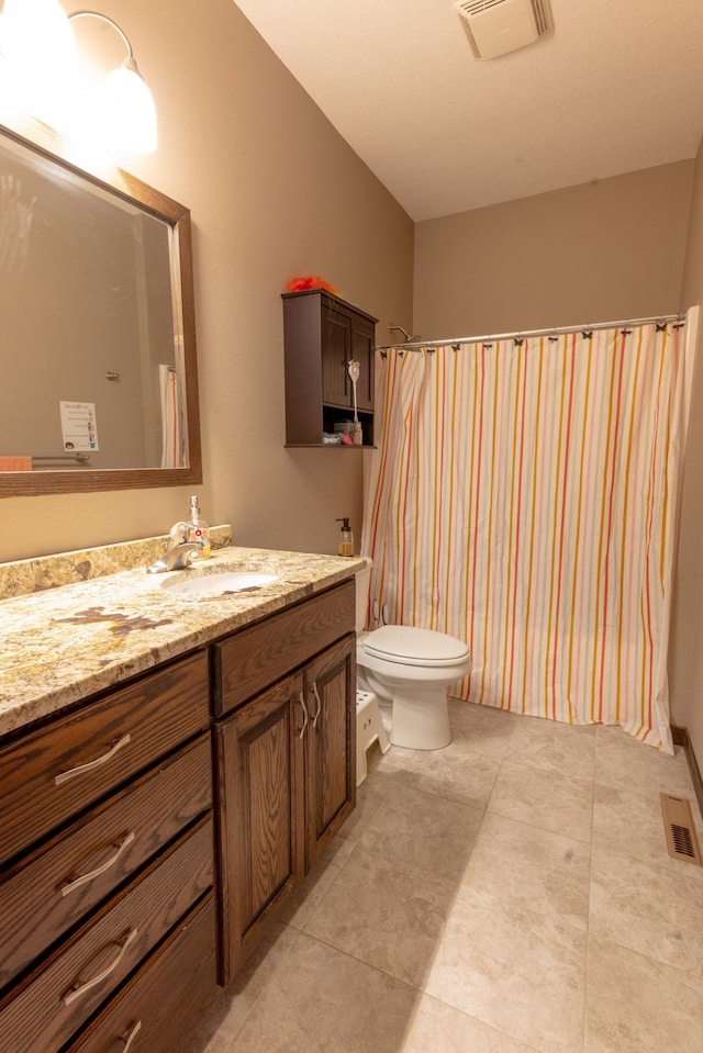 bathroom with vanity, a shower with shower curtain, toilet, and tile patterned floors