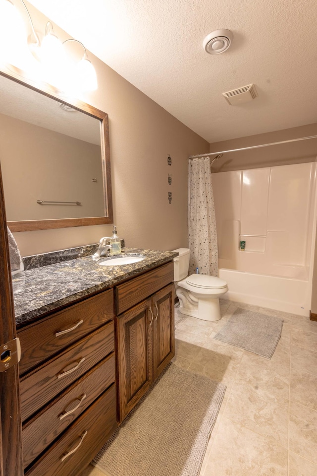 full bathroom featuring vanity, toilet, shower / bath combination with curtain, and a textured ceiling