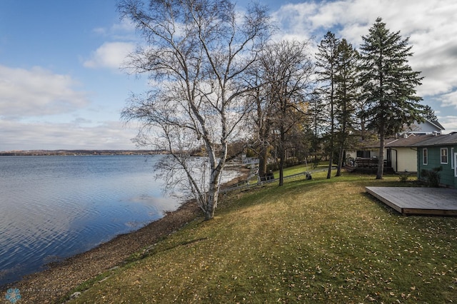 exterior space featuring a deck with water view