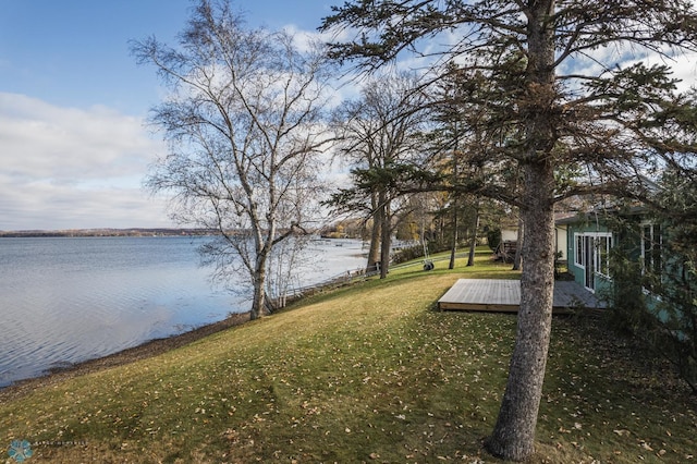 view of yard with a deck with water view