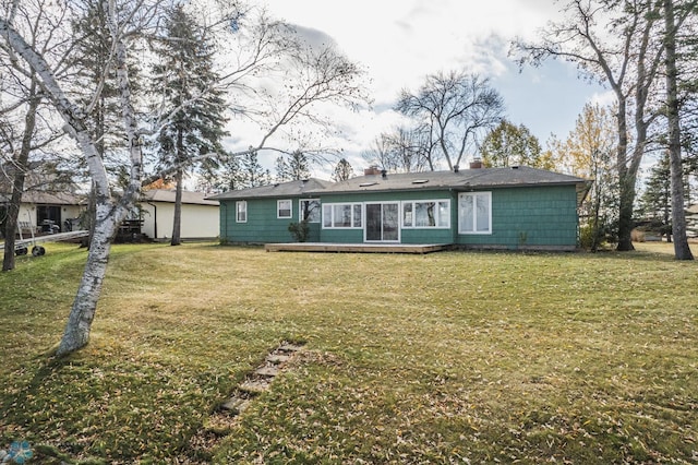 rear view of house featuring a yard