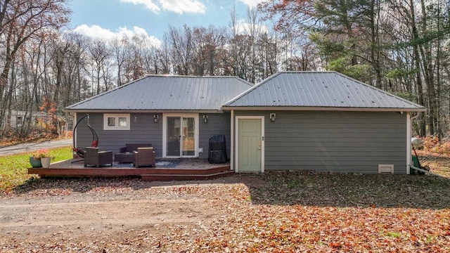 back of house with a wooden deck