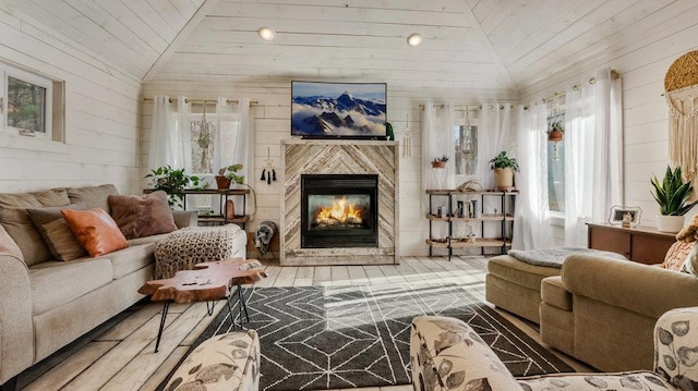 living room featuring lofted ceiling, hardwood / wood-style flooring, wooden walls, and wooden ceiling