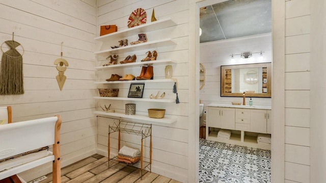 bathroom featuring vanity, wood walls, and hardwood / wood-style floors