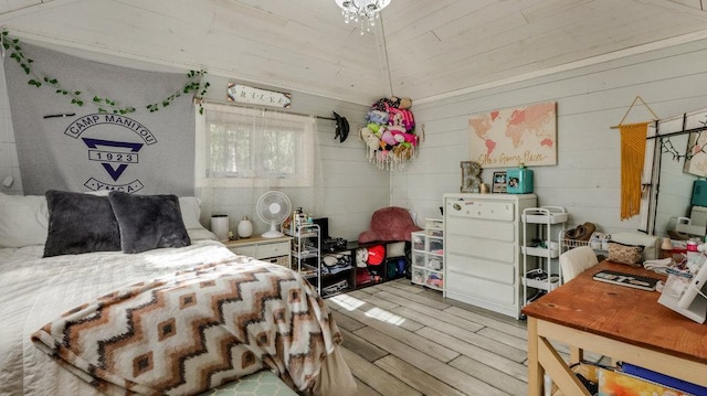 bedroom with light hardwood / wood-style floors and lofted ceiling