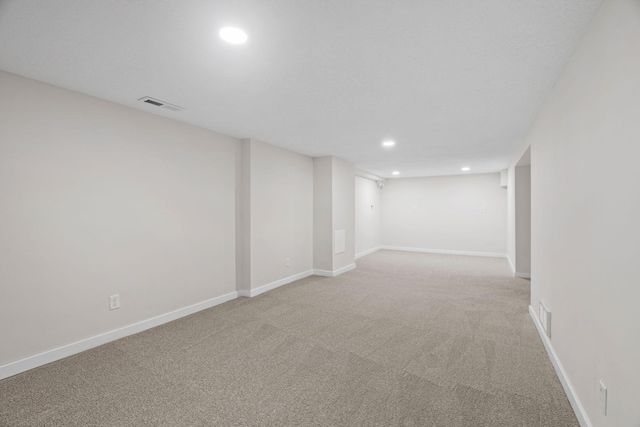 basement featuring light colored carpet