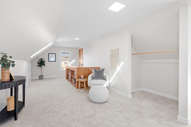 sitting room with lofted ceiling and light colored carpet