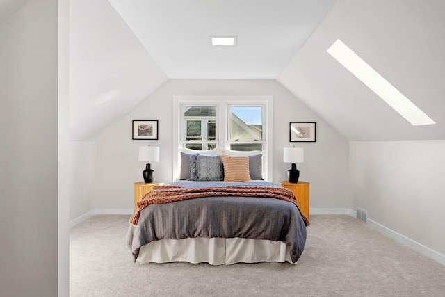 carpeted bedroom with lofted ceiling with skylight