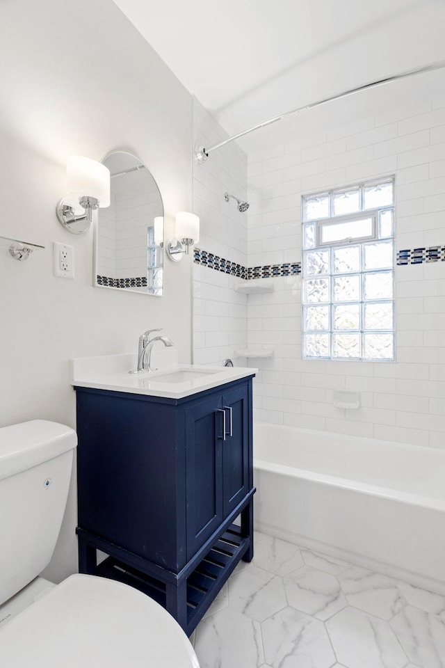 full bathroom featuring vanity, toilet, and tiled shower / bath combo