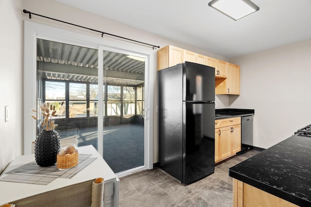 kitchen with black refrigerator, dishwasher, and light brown cabinets