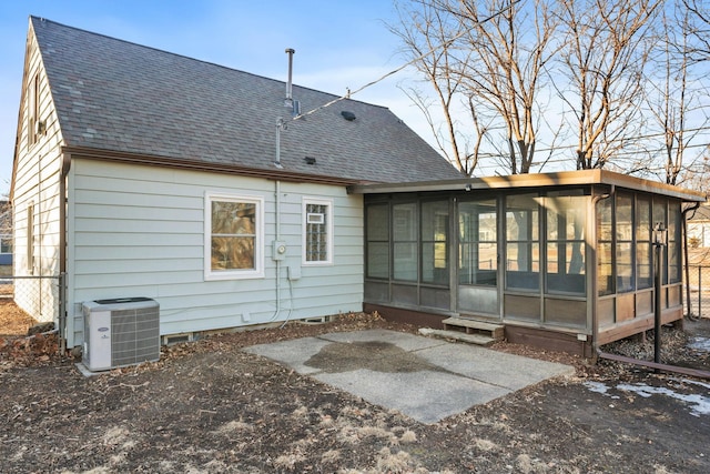 back of house featuring a sunroom and central air condition unit