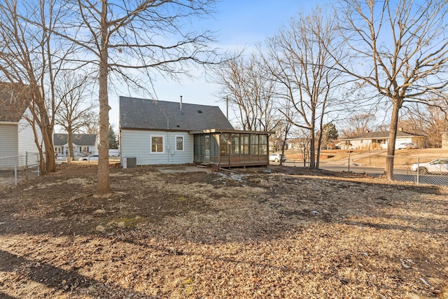 back of property featuring a sunroom and central AC