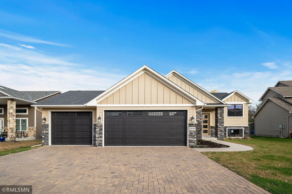 craftsman-style home with a front yard and a garage