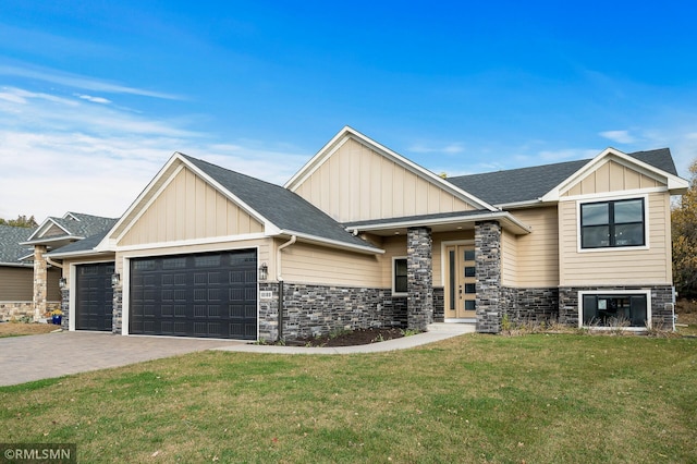 view of front of house featuring a garage and a front lawn