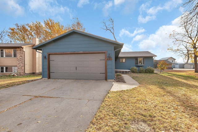 ranch-style house with a garage and a front lawn