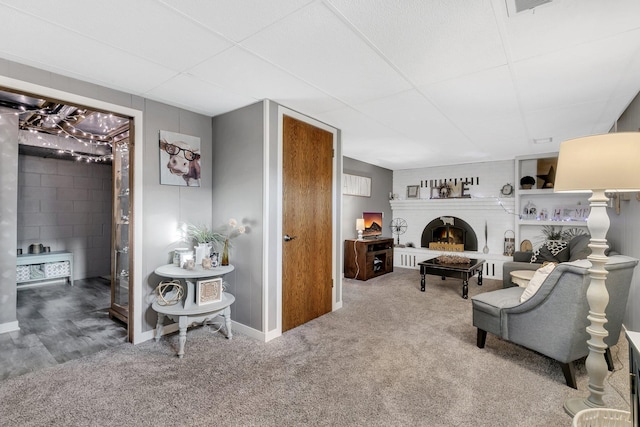 carpeted living room with a fireplace