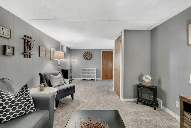 carpeted living room with a wood stove