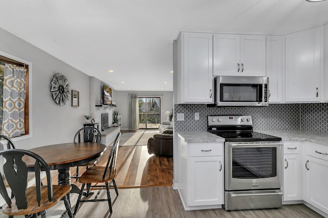 kitchen featuring white cabinetry, stainless steel appliances, and light hardwood / wood-style flooring