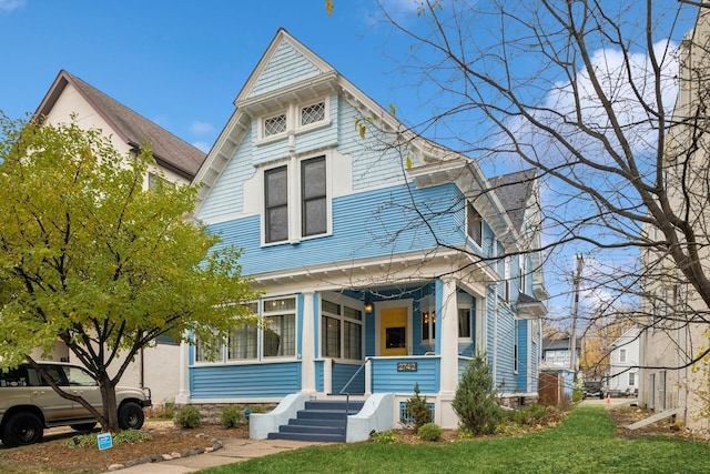 2742 Dupont Ave S, Minneapolis, MN 55408 - victorian-style house featuring a porch and a front lawn