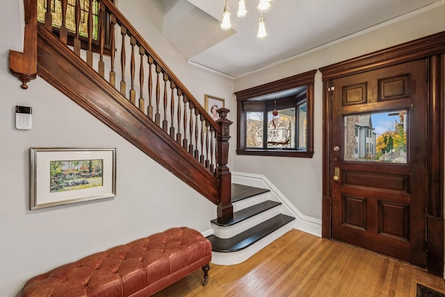 2742 Dupont Ave S, Minneapolis, MN 55408 - foyer entrance with stairway, hardwood / wood-style flooring, and a chandelier