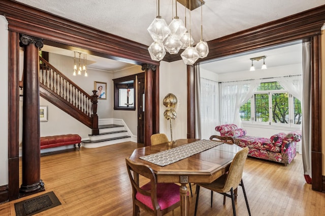 2742 Dupont Ave S, Minneapolis, MN 55408 - dining space featuring a chandelier, plenty of natural light, stairway, and ornamental molding