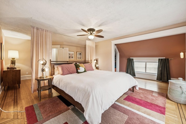 2742 Dupont Ave S, Minneapolis, MN 55408 - bedroom with wood-type flooring, ceiling fan, and a textured ceiling
