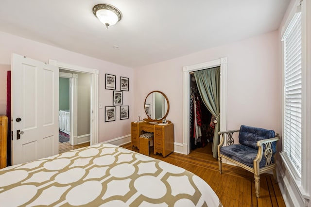 2742 Dupont Ave S, Minneapolis, MN 55408 - bedroom with a closet, multiple windows, and wood finished floors