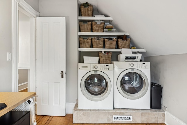 2742 Dupont Ave S, Minneapolis, MN 55408 - laundry room with separate washer and dryer and wood finished floors