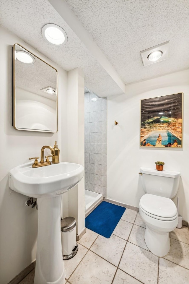 2742 Dupont Ave S, Minneapolis, MN 55408 - full bath with a stall shower, a textured ceiling, and tile patterned flooring