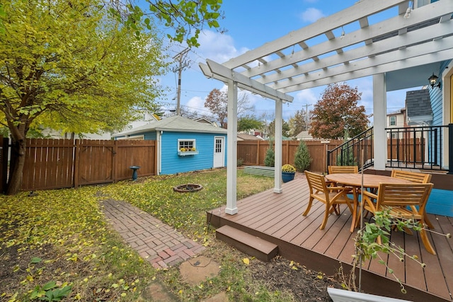 2742 Dupont Ave S, Minneapolis, MN 55408 - wooden deck featuring a fenced backyard, outdoor dining area, a fire pit, an outbuilding, and a pergola