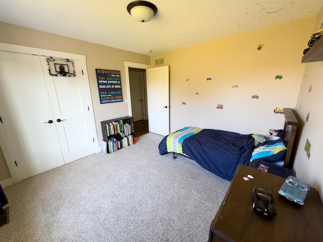 bedroom featuring a closet and carpet