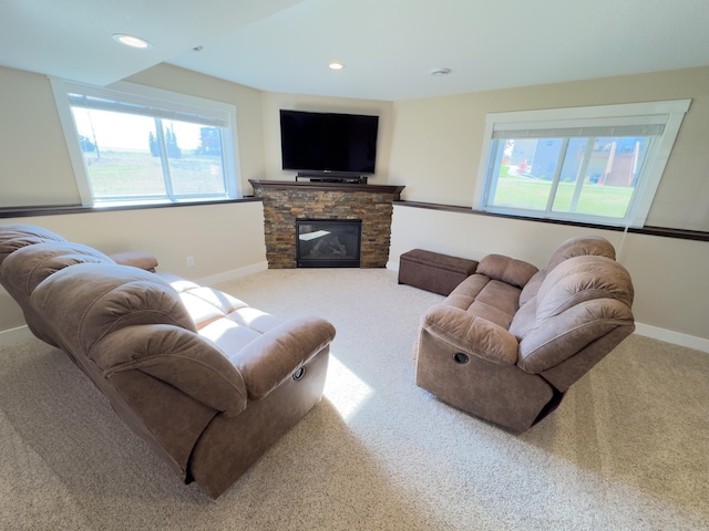 living room with a fireplace, carpet floors, and plenty of natural light