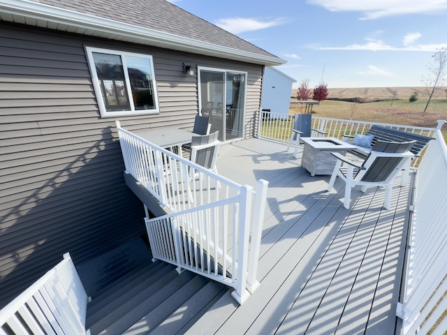 wooden deck with an outdoor fire pit