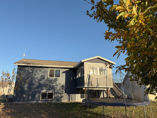 rear view of house with a trampoline